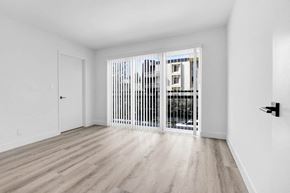 Los Angeles apartment for rent - a living room with a large window and a door to a balcony