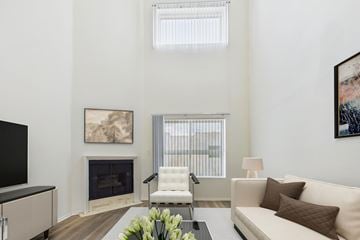 Valley Village apartment for rent - A living room with a fireplace, a white couch, and a painting on the wall.