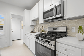 Los Angeles apartment for rent - A modern kitchen with white cabinets and a black stove top.
