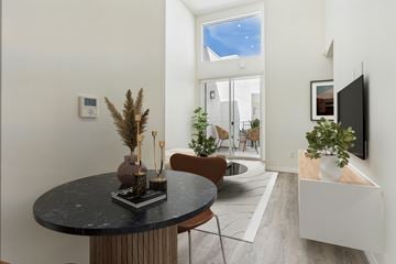 Van Nuys apartment for rent - A modern living room with a round table and a flat screen TV.