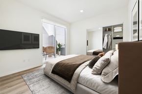 Van Nuys apartment for rent - A bedroom with a large bed and a flat screen TV mounted on the wall.