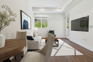 Los Angeles apartment for rent - A modern living room with a wooden table and a large painting on the wall.