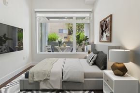 Los Angeles apartment for rent - A modern bedroom with a large bed and a view of the outdoors.