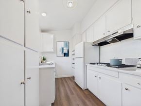 North Hollywood apartment for rent - A kitchen with white cabinets and a wooden floor.