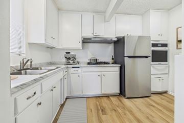 North Hollywood apartment for rent - A kitchen with white cabinets and a stainless steel refrigerator.