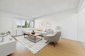 North Hollywood apartment for rent - A living room with a white couch, a coffee table, and a chair.