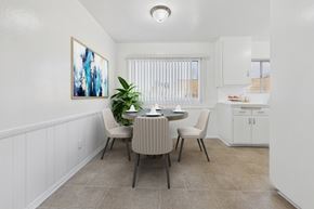 North Hollywood apartment for rent - A dining room with a table set for two and a painting on the wall.