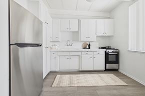 Van Nuys apartment for rent - A modern kitchen with white cabinets and a stainless steel refrigerator.