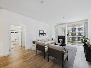 Los Angeles apartment for rent - A living room with a white couch and a black chair.