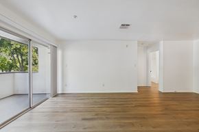 Pasadena apartment for rent - A spacious room with wooden floors and white walls.