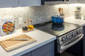 Canoga Park apartment for rent - A kitchen counter with a Mediterranean cookbook, a blue bowl, and a wooden cutting board.