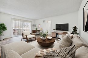 Van Nuys apartment for rent - A living room with a couch, a chair, a coffee table, and a television.