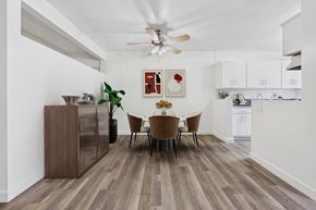 Van Nuys apartment for rent - A dining room with a wooden floor and a white ceiling fan.
