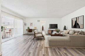 Van Nuys apartment for rent - A living room with a couch, chair, and television.