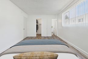 Van Nuys apartment for rent - A bedroom with a bed and a window with blinds.