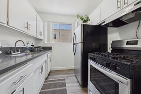 Van Nuys apartment for rent - A kitchen with a black refrigerator and stove.
