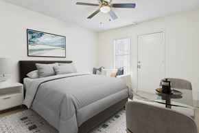 Canoga Park apartment for rent - A bedroom with a bed, chair, and a ceiling fan.