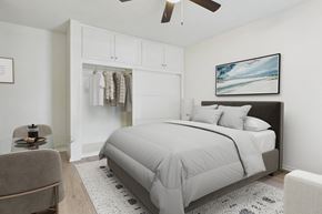 Canoga Park apartment for rent - A bedroom with a large bed and a ceiling fan.