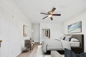 Canoga Park apartment for rent - A bedroom with a bed, chair, and a ceiling fan.