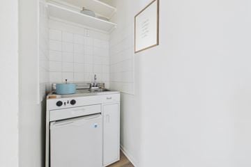 Canoga Park apartment for rent - A white kitchen with a dishwasher and a stove top.