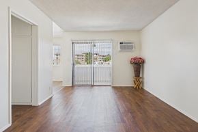 Panorama City apartment for rent - A white room with a wooden floor and a white door.