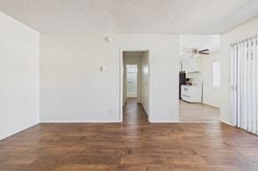 Panorama City apartment for rent - A room with wooden floors and white walls.