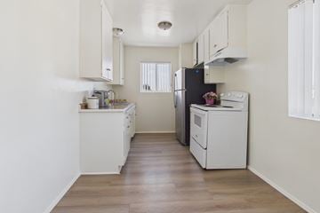 Panorama City apartment for rent - A kitchen with white cabinets and appliances.