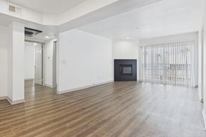 Los Angeles apartment for rent - A spacious room with wooden flooring and white walls.