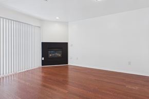 Los Angeles apartment for rent - A room with a fireplace and wooden floors.