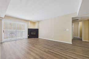Los Angeles apartment for rent - A spacious living room with a fireplace and sliding glass doors.