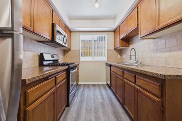 Los Angeles apartment for rent - A kitchen with wooden cabinets and a stainless steel refrigerator.