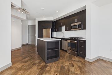 Culver City townhouse for rent - A modern kitchen with dark wood floors and stainless steel appliances.