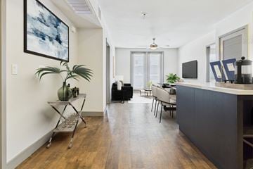 Culver City townhouse for rent - A living room with a black couch and a wooden floor.