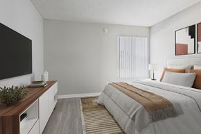 North Hills apartment for rent - A bedroom with a large bed and a television on the wall.