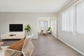Garden Grove apartment for rent - A living room with a white sofa and a television.