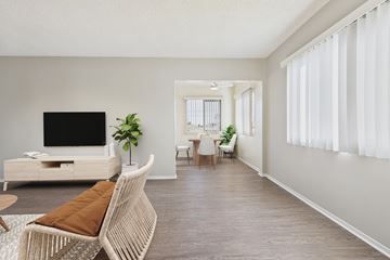Garden Grove apartment for rent - A living room with a white sofa and a television.