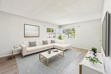 Garden Grove apartment for rent - A living room with a white couch and a painting on the wall.