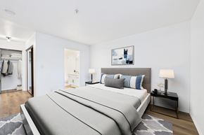 Pasadena apartment for rent - A bedroom with a large bed and a painting on the wall.