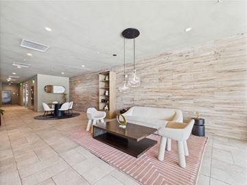 Los Angeles apartment for rent - A modern living room with a white couch and a wooden wall.