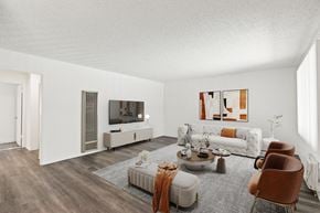 Bellflower apartment for rent - a living room with a couch and a table and a television