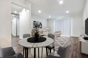 Mission Hills apartment for rent - A modern dining room with a round marble table and grey chairs.