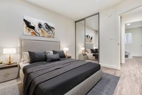 Mission Hills apartment for rent - A bedroom with a large bed and a painting on the wall.