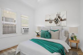 Los Angeles apartment for rent - A bedroom with a large bed and a painting above it.