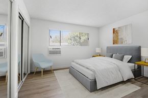 Los Angeles apartment for rent - a bedroom with a bed and a chair and a sliding glass door