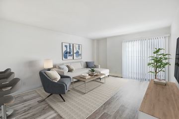 Northridge apartment for rent - A living room with a grey chair and a white couch.