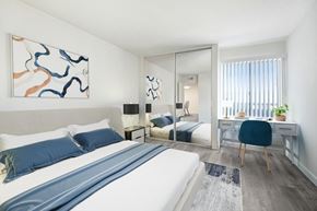 Northridge apartment for rent - A bedroom with a large bed and a painting on the wall.