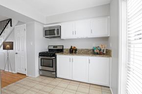 Marina Del Rey townhouse for rent - a kitchen with stainless steel appliances and white cabinets