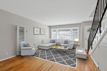 Marina Del Rey townhouse for rent - a living room with couches and a rug in front of a staircase