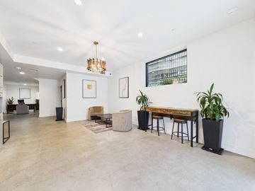Los Angeles apartment for rent - A modern living room with a wooden table and bar stools.