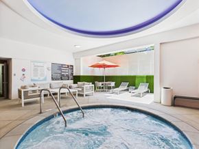 Santa Monica apartment for rent - A round pool with a hot tub in the middle of it.